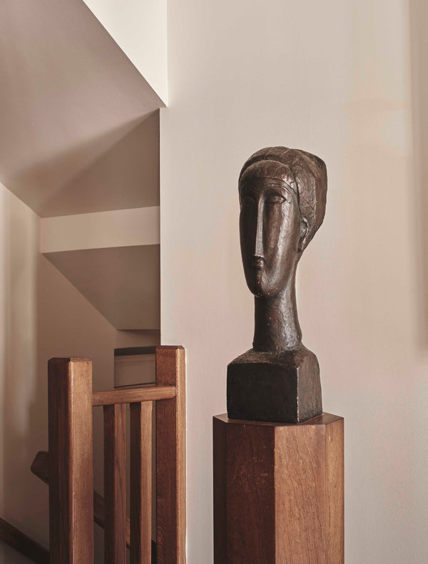 Bronze bust with oak stand stands among the emotive Italian marmorino
