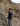 Mitch Iburg reaching out to pick a piece of wild clay from a side of a cliff or a foot of a mountain