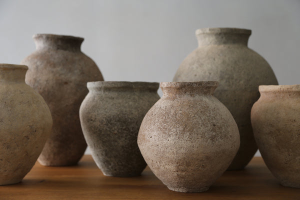 A collection of Mitch Iburg ceramics made from wild clay on a table