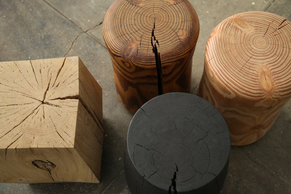 Looking down on Four Noorstad stools in various shades of oak and black