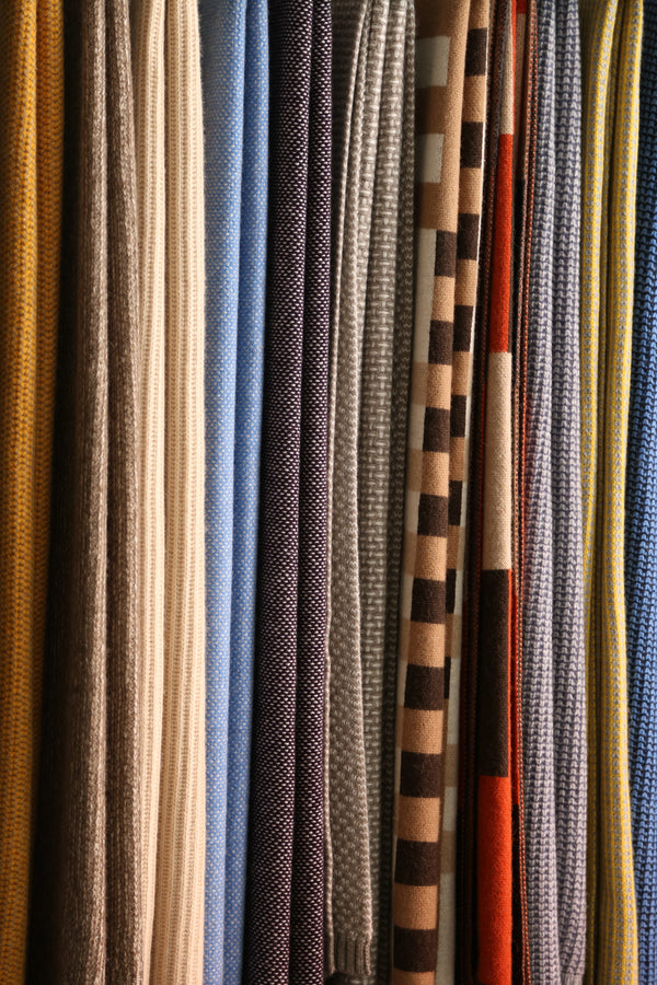 A close-up of Hangai Mountain Textiles' throws and blankets hung next to each other