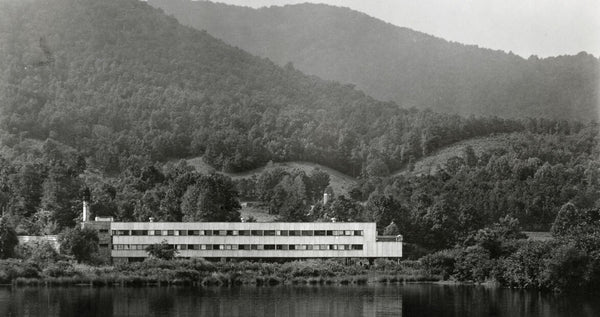 Black Mountain Collage against a backdrop of rolling mountains and lake