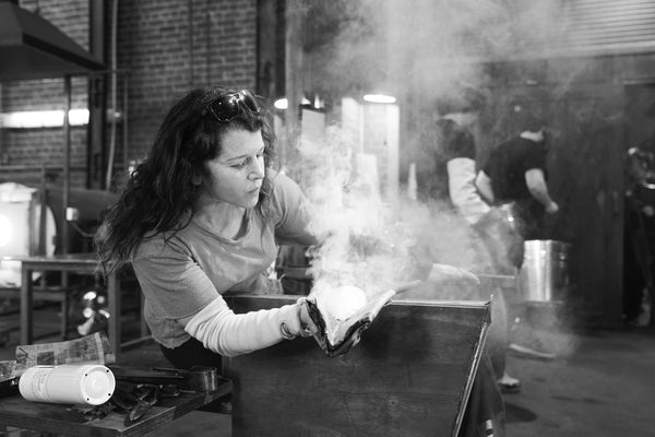 Andi Kovel blowing glass in black and white