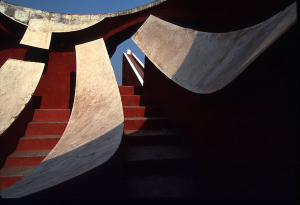 The view from the bottom of the stairs at Jantar Mantar looking up with linear structures framing the sky
