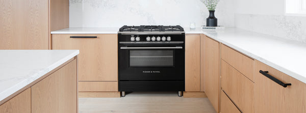 Fisher & Paykel oven and stovetop at the kitchen Atelier 211 made with white marble countertops and oak cabinetry