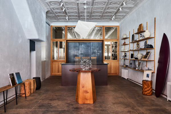 Homage to Four Friends in the center of the retail space of Studio Zung with a Noguchi lamp hanging from the ceiling